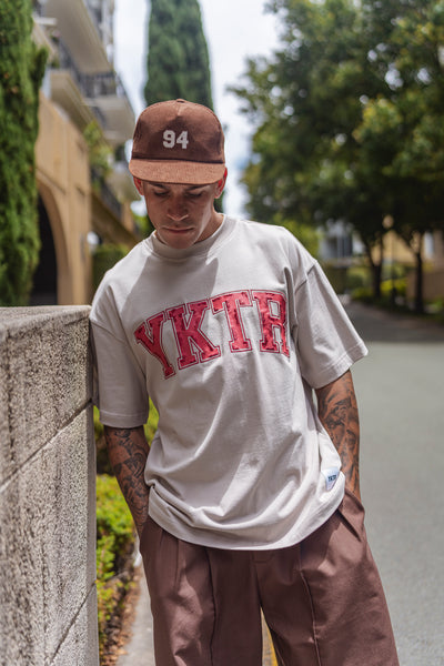 VARSITY O/S EMB TEE - STONE